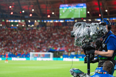 Man carries TV camera on the stabilizer at football stadiumの写真素材