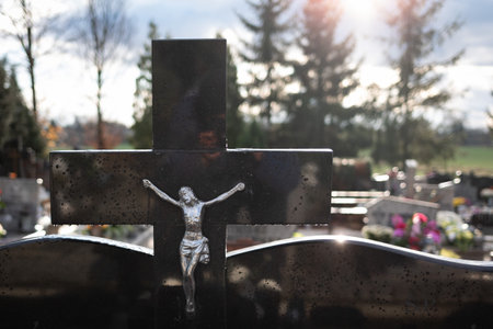 crucyfix on the grave with autumn trees in the backgroundの写真素材