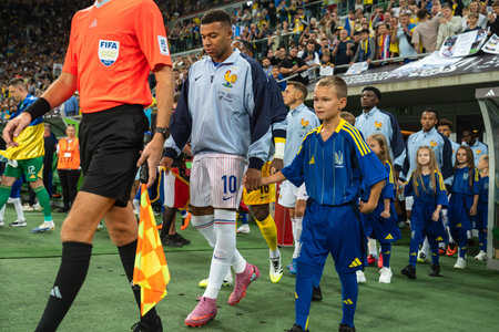 WROCLAW; POLAND - SEPTEMBER 5; 2025: Qualifications for FIFA 2026. Football match Ukraine vs France 0:2. Captain Mbappe Kylian with boy and team of France before the game.のeditorial素材
