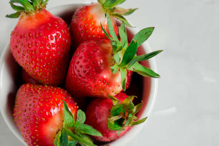 Fresh strawberries. Strawberry background. Macro texture. big, big strawberries. On a blue background. Harvesting clean local strawberries. copyspaceの写真素材