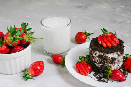 Tasty fresh milk on a white wooden background. homemade cookies and a glass of milk. Strawberry.の写真素材