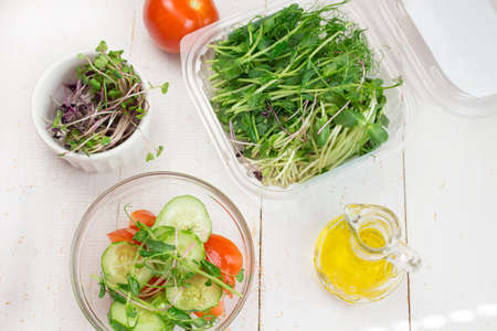 Salad. Vegetable salad. Spring vegetable salad. Fresh vegetable salad with tomatoes onion cucumber and olive oil. The ingredients. View from above.の写真素材