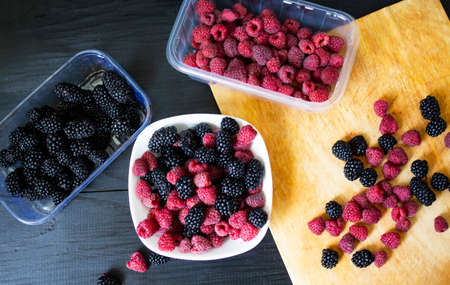 berries View from above. tasty berries on a dark background. Assorted berries background. Raspberries and blackberries. Copy space.Raspberry and mulberry. Copy space.の写真素材