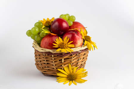 Fresh fruits. Healthy food. Mixed fruit, peaches and grapes. Studio photography of various fruits on an old wooden table. Organic healthy assorted fruits. Fruit in a basket. Fruit food background.の写真素材