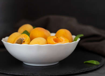 Fresh fruits. Healthy food. Mixed fruit, apricots and peaches. Studio photography of various fruits on an old wooden table. Organic healthy assorted fruits. Assortment of fresh fruit.の写真素材