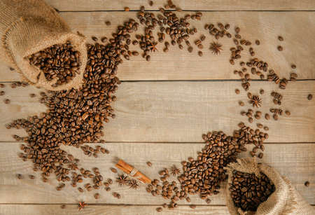 Coffee beans in a mug, a cup of coffee full of coffee beans, coffee cup with roasted beans on a wooden background. Copy spaceの写真素材