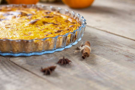 Fresh pumpkin pie. Pumpkin pie. Pie on a brown wooden table. Copy spaceの写真素材