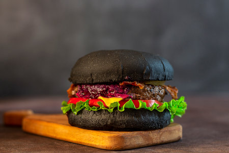 Fresh tasty black burger on a black background. Close-up.の写真素材