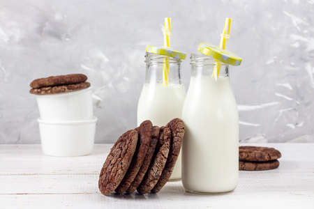 Delicious fresh milk on a white wooden background. a glass of milk. Chocolate chip cookies. copy spaceの写真素材