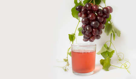 Grape. A bunch of pink grapes with a grape leaf on a white background. cup. Banner. copy spaceの写真素材
