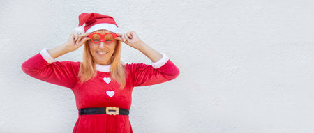 Christmas card. Christmas background. Santa girl in red glasses on a white background. Banner. copy spaceの写真素材