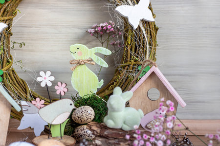 Easter background with Easter wreath and colored Easter eggs and blooming flowers. Easter composition. Easter. copy spaceの写真素材