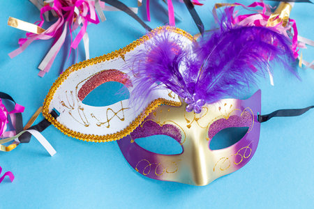 Festive face mask for carnival celebration on blue background. Mardi gras carnival background with carnival masks.の写真素材