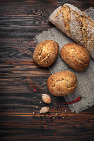 A set of products from bread of garlic pepper on a wooden tableの写真素材