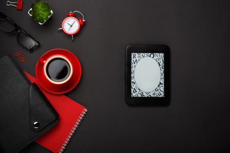 black background red coffee cup note pad alarm clock flower diary glasses