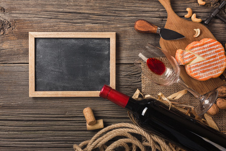 Holiday Dinner setting with red wine and creaming cheese on rustic wood. Top view with space for your greetingsの写真素材