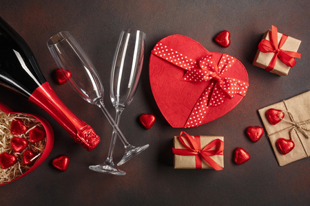Valentine's Day with a bottle of champagne glasses of chocolates and gifts. Top view with copy spaceの写真素材