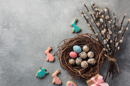 Easter gingerbread cookies on wooden table. Rabbits and eggs. Greeting card. Top view with space for...