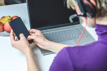 woman working from home using an smartphone