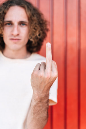 Hand with middle finger raised with rude gestureの写真素材