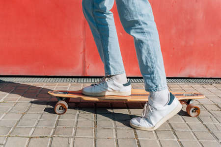 feet with sport shoes on a skateboard in the streetの写真素材