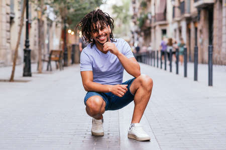 horizontal portrait of hispanic man with dreadlocks in the streets of barcelonaの写真素材