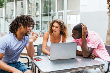 Multiethnic group of students preparing together work for university studies