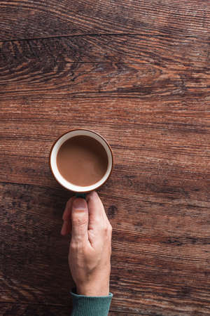 Crop man with cup of coffeeの写真素材