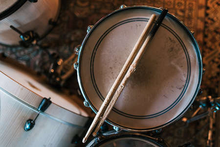 Wooden drumsticks on drum after concert