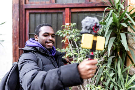 Black blogger shooting video on street