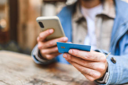 Unrecognizable male client paying for online order