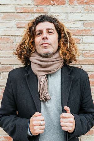 Self assured male adjusting coatの写真素材