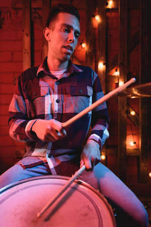 Musician playing drums during concertの写真素材