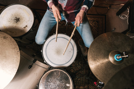 Man playing music on drum set in studioの写真素材