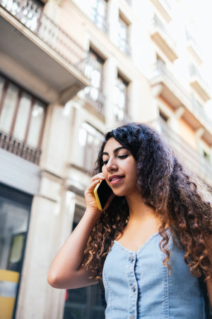 Indian Female traveler speaking on a phone on streetの写真素材