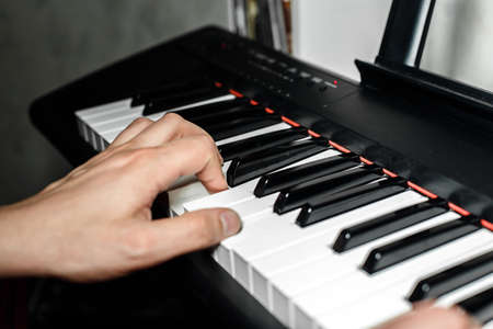 the pianist plays the piano. The pianist's hands closely. the view from the topの写真素材