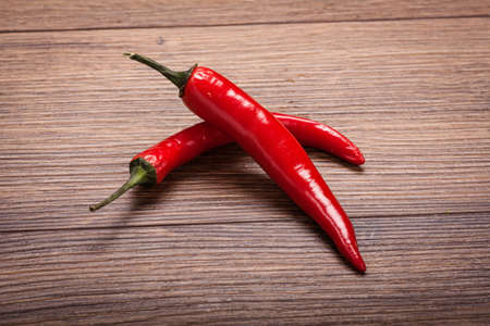 fresh red chili on a wooden surface
