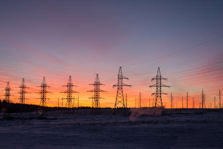 silhouettes of power lines, the theme of ecology. silhouettes on the sunset sky. Power pylonsの写真素材