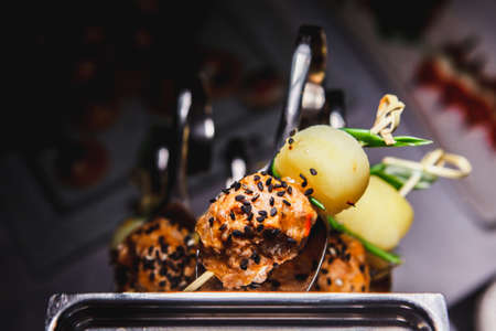 Food collage of snacks with meat and vegetables. Tapas with strawberries and cheese, salmon with pickled cucumber. Prosciutto with pears and arugulaの写真素材