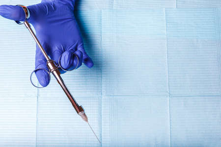 dental and endodontic instruments in hands. Top view.