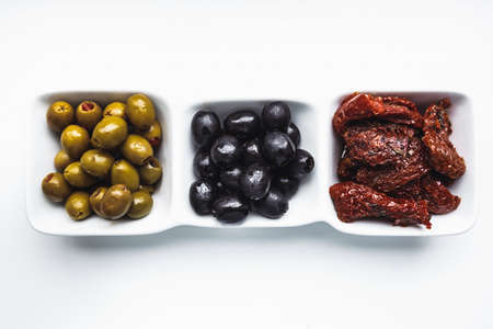 olives in nice plate on white background.の写真素材