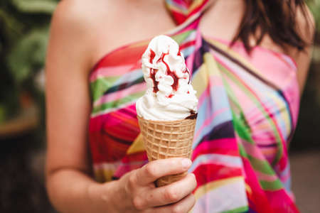 Happy girl enjoy eating with icecream on playgroundの写真素材