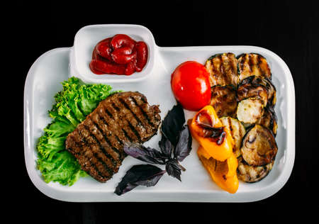 European international fusion cuisine, a beautiful dish on a white plate decorated with herbs and vegetables. a professional chef has prepared a delicious meal. Vegetarian food and meat restaurant dishes. fast food.の写真素材