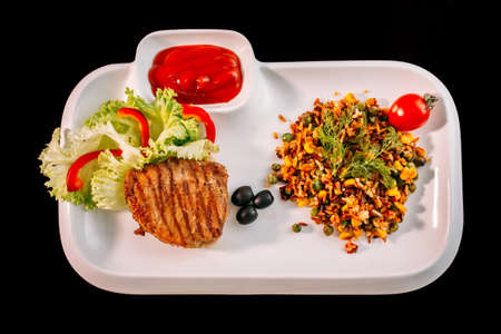 European international fusion cuisine, a beautiful dish on a white plate decorated with herbs and vegetables. a professional chef has prepared a delicious meal. Vegetarian food and meat restaurant dishes. fast food.の写真素材