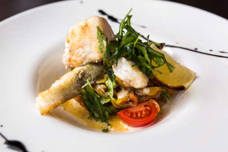 European international fusion cuisine, a beautiful dish on a white plate decorated with herbs and...