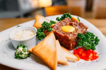 European international fusion cuisine, a beautiful dish on a white plate decorated with herbs and vegetables. a professional chef has prepared a delicious meal. Vegetarian food and meat restaurant dishes. fast food.の写真素材