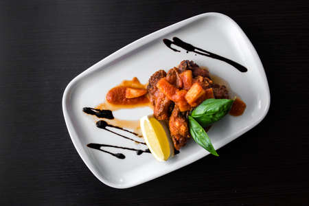 European international fusion cuisine, a beautiful dish on a white plate decorated with herbs and...