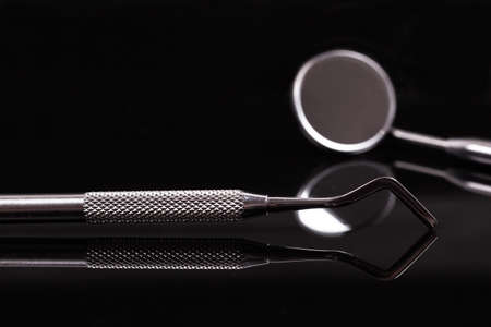 dental and endodontic restoration instruments on a black dark background. Top view