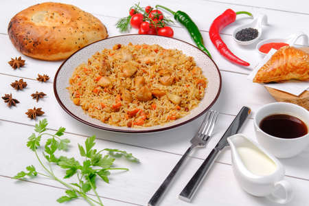 The concept of oriental cuisine. Assorted Uzbek food set, pilaf, samsa, lagman, manta, shurpa Uzbek...