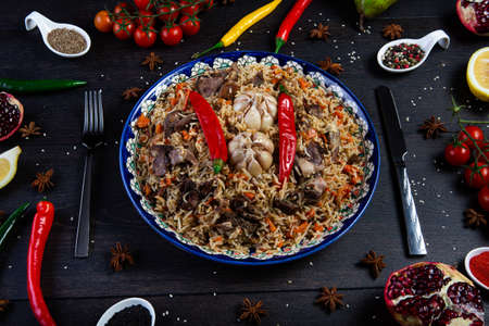 The concept of middle East cuisine. Assorted Uzbek food set, pilaf, samsa, lagman, manti, shurpa eastern restaurant concept, Uzbek food. pilaf or plov from lamb served in cast iron cookware.の写真素材